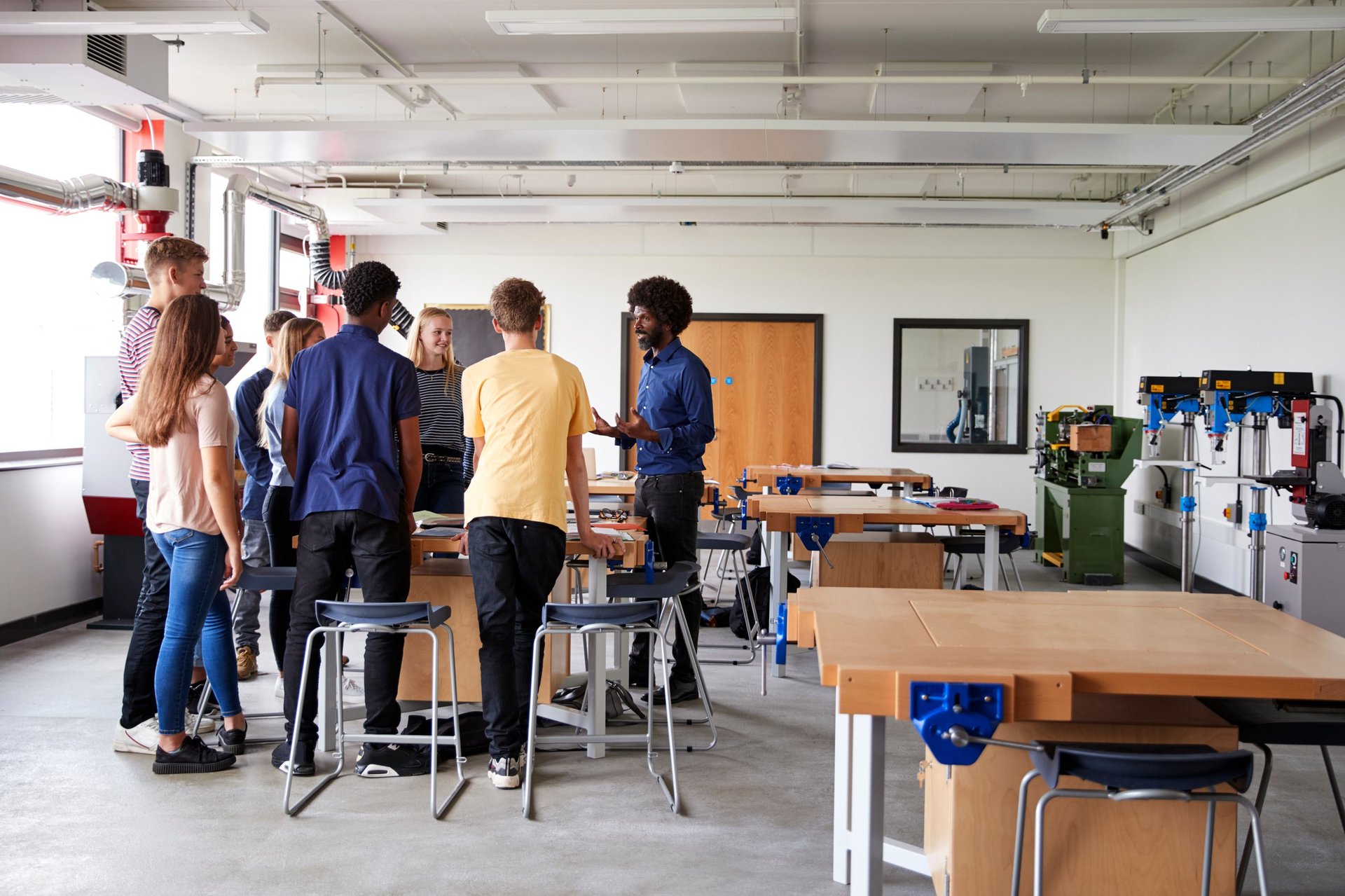 Lighthouse Milton 6–12 students gathered around a work bench during a hands-on design and technology lesson