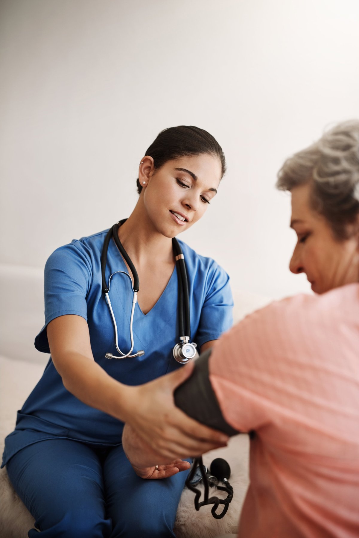 Nurse checking a senior patient's blood pressure
