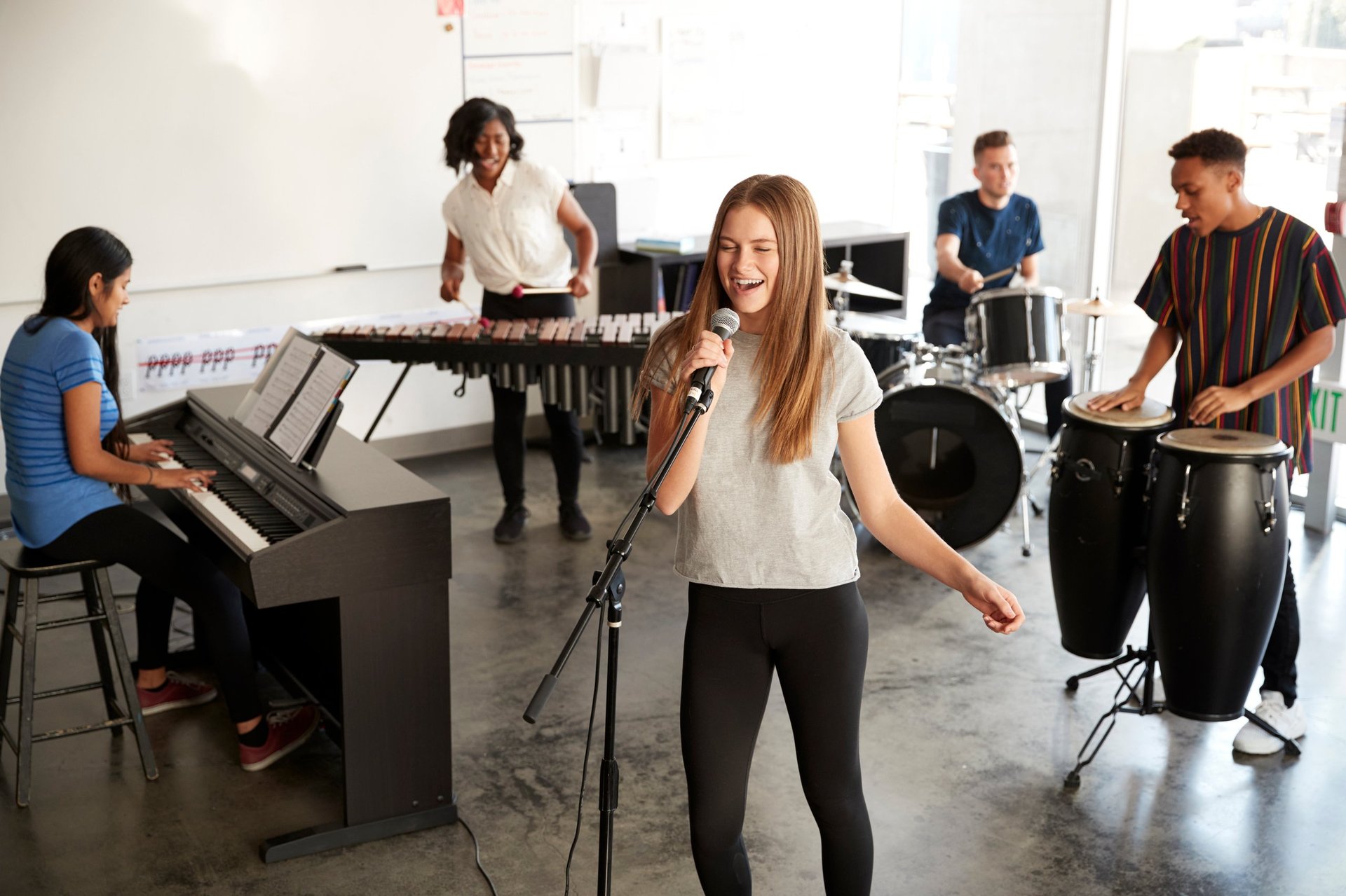 Students at performing arts school playing in a band at rehearsal