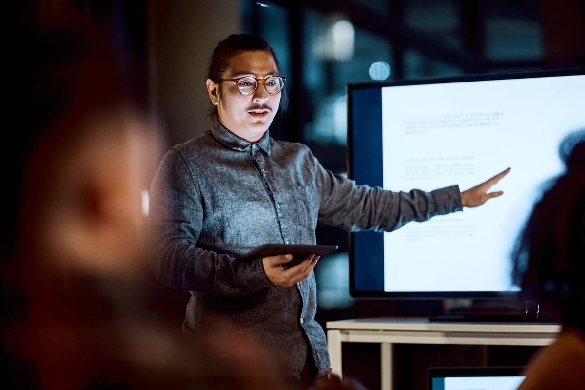 Young businessman delivering a presentation during a late night meeting