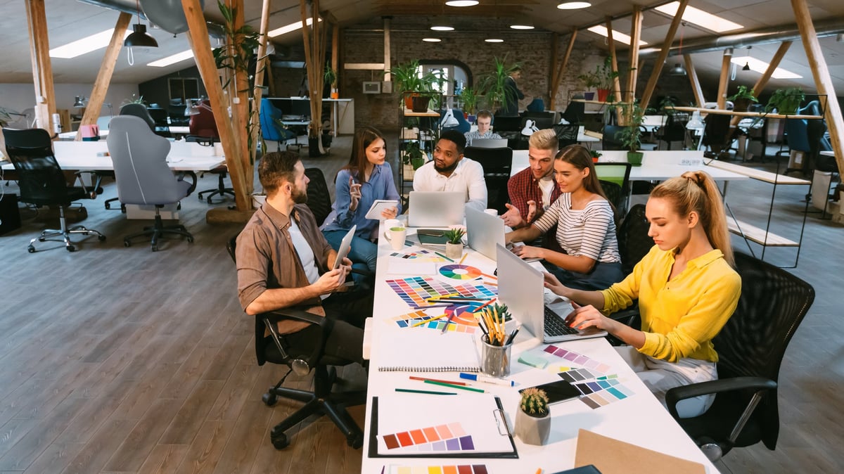 Designers collaborating on a project in a modern open-plan studio