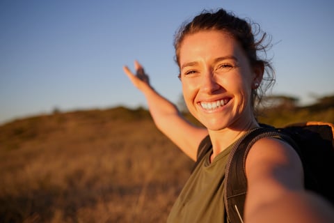 Young woman taking a selfie while hiking — freedom