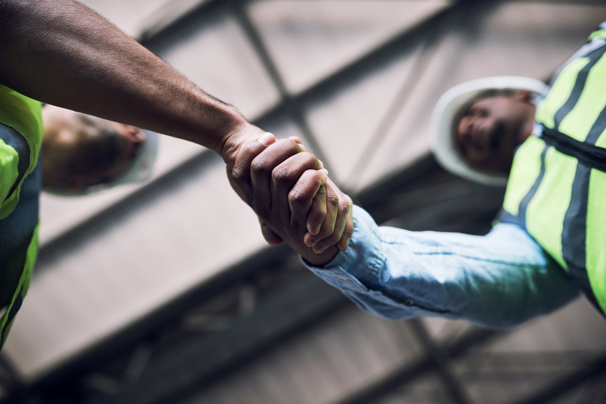 Adults working together in the community, symbolizing teamwork and reintegration