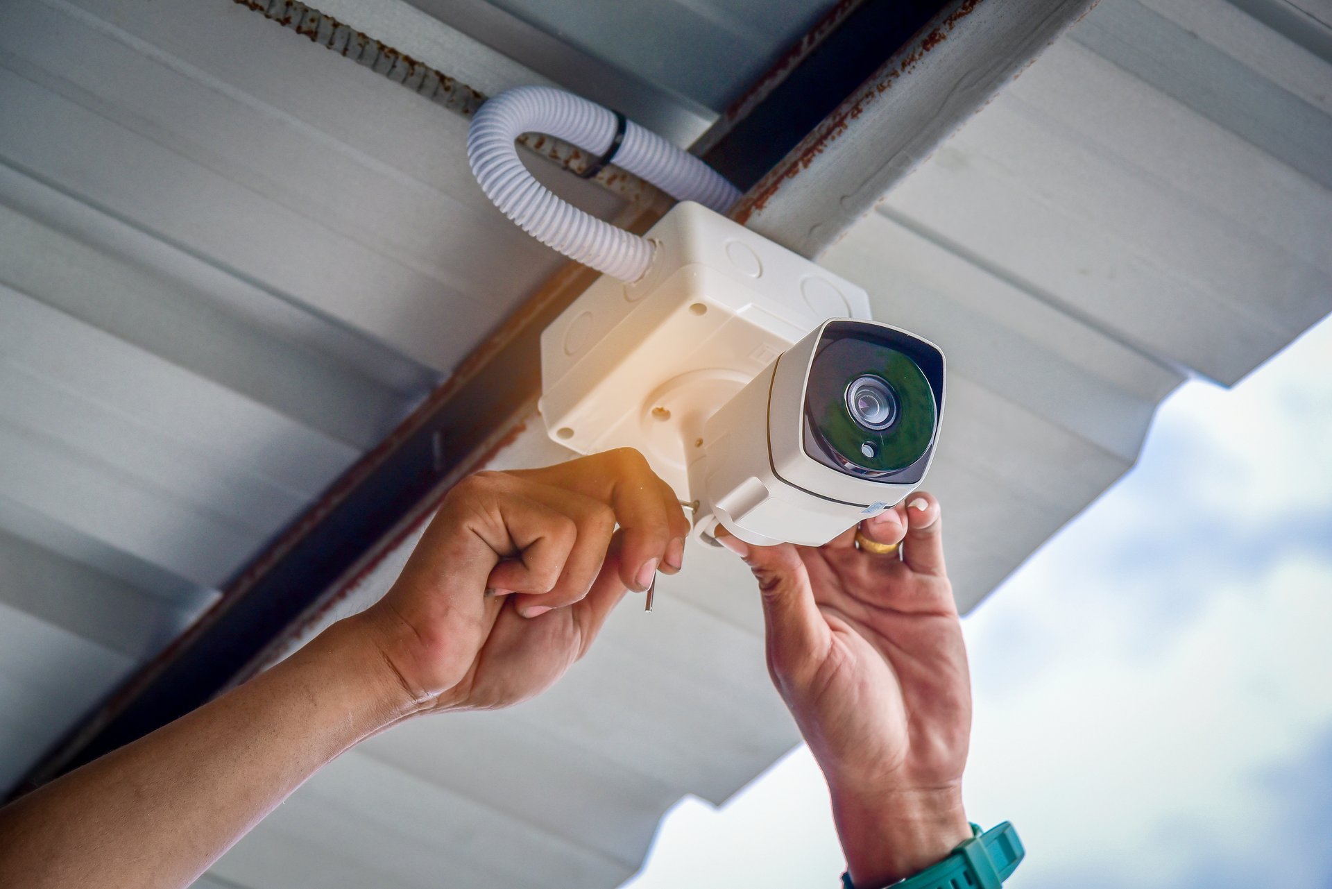 Dylco Electric technician installing a security camera for a Westfield home