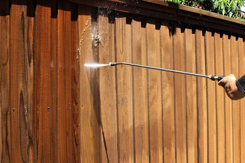 Wood fence being soft washed