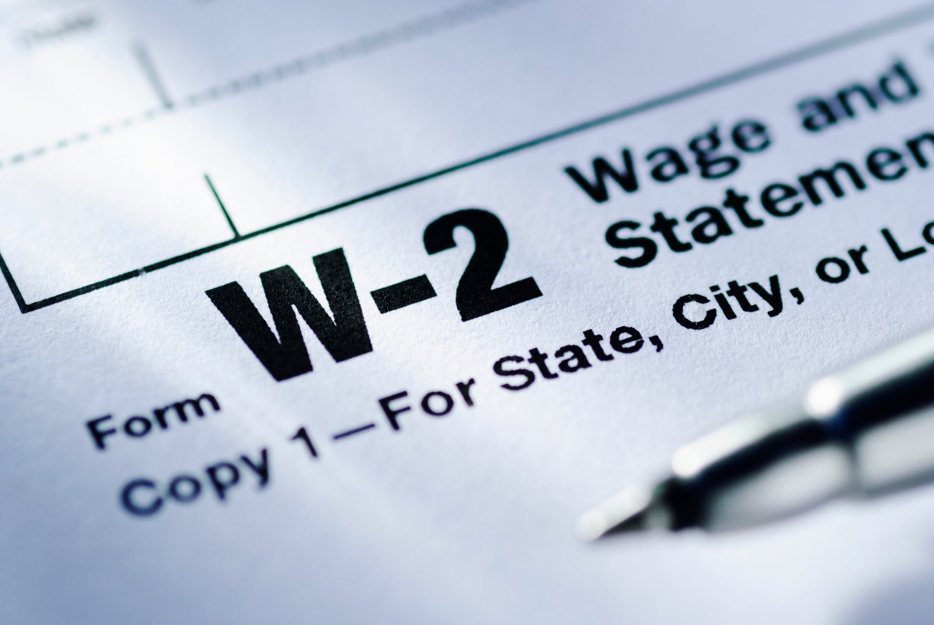 IRS Form W-2 Wage and Tax Statement on desk