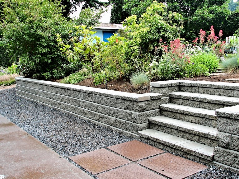 Retaining wall with built-in steps and stepping stones