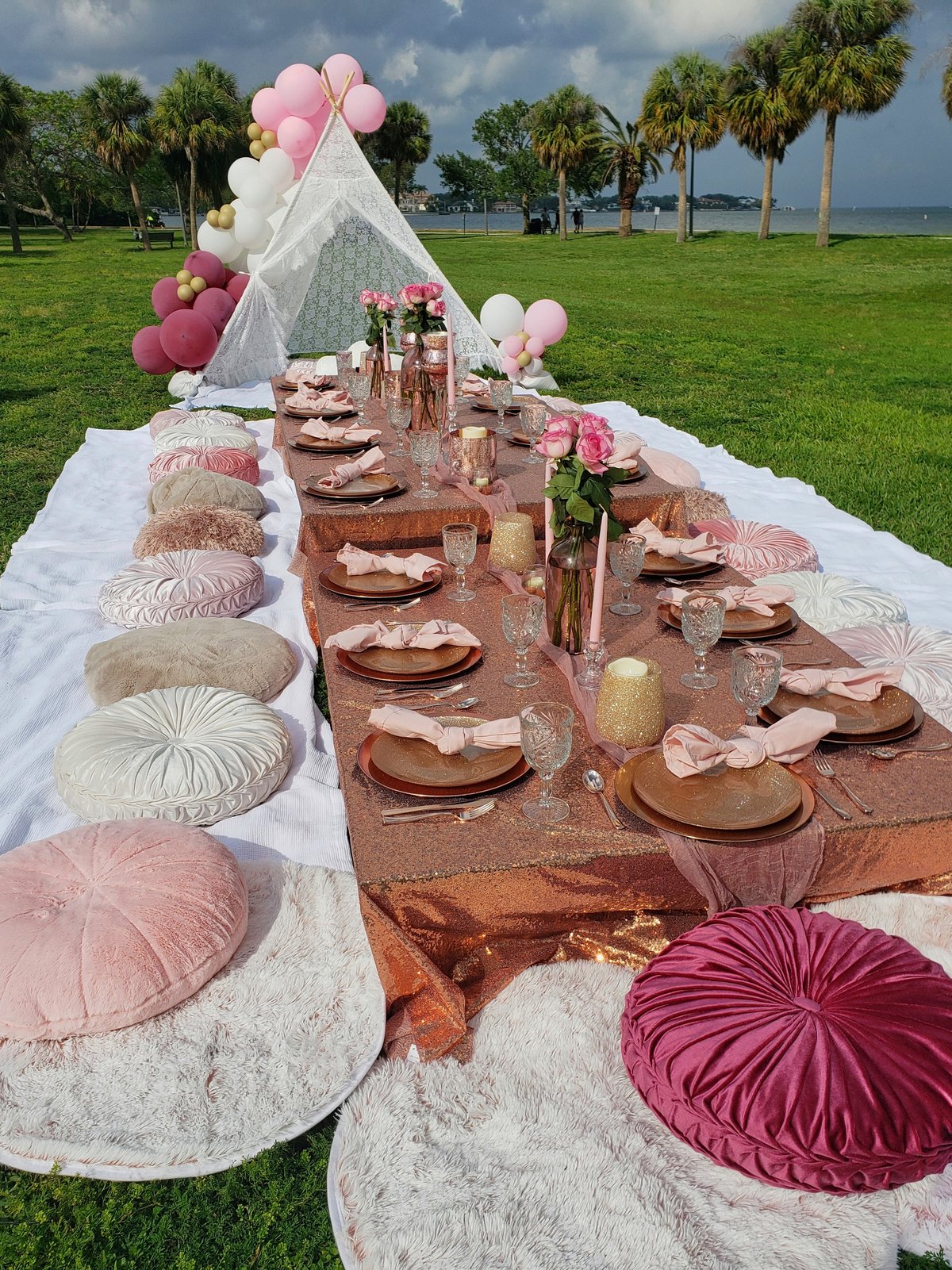 An elaborate table setting for an outdoor party at a park