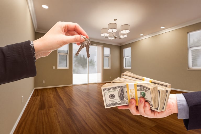 Agent handing over house keys for cash in newly remodeled room