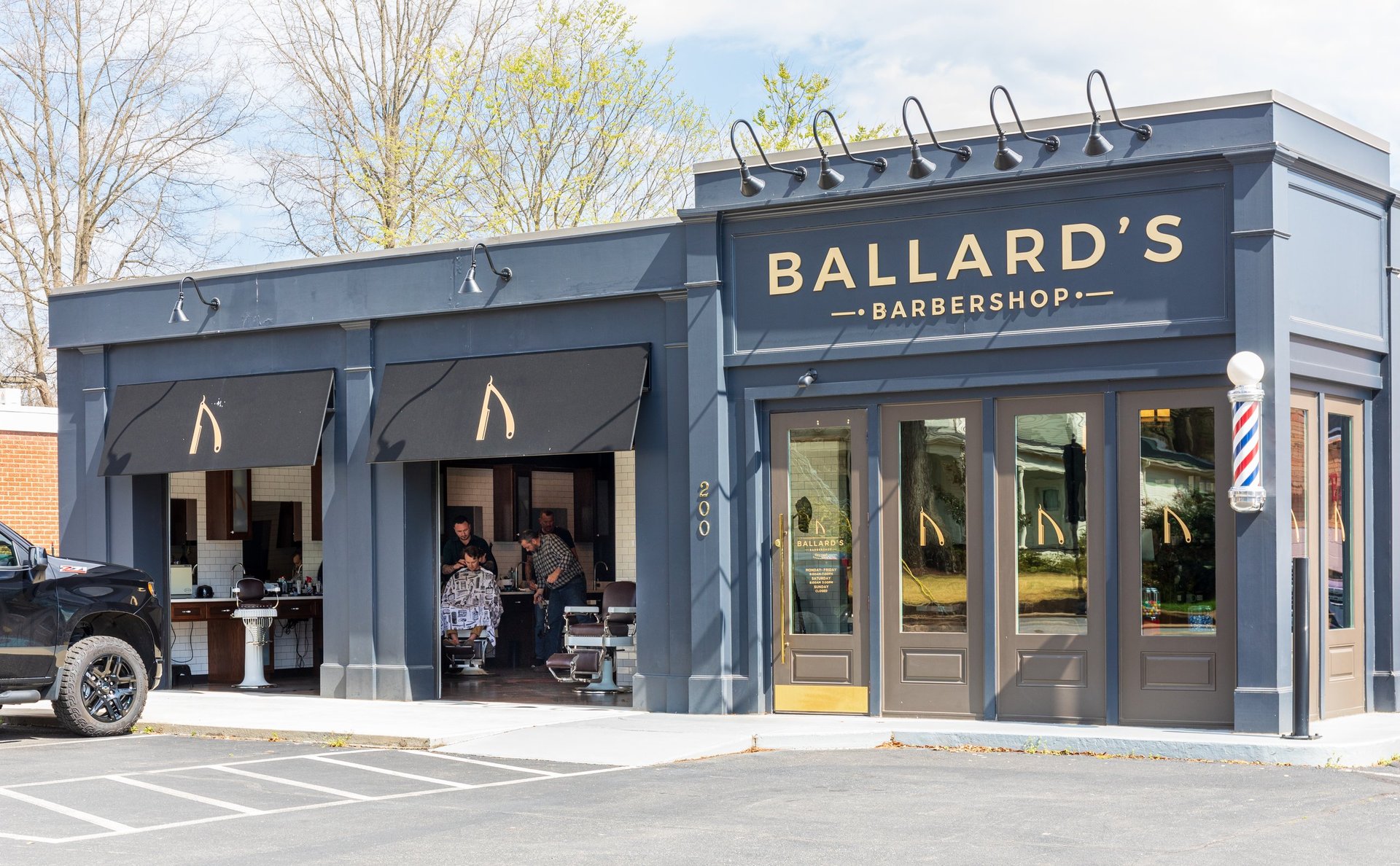 Ballard's Barbershop in a former service station building with an open-air parlour