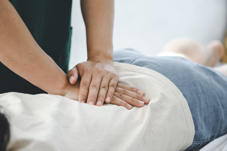 Doctor helping patient during rehabilitation at Bagley Chiropractic