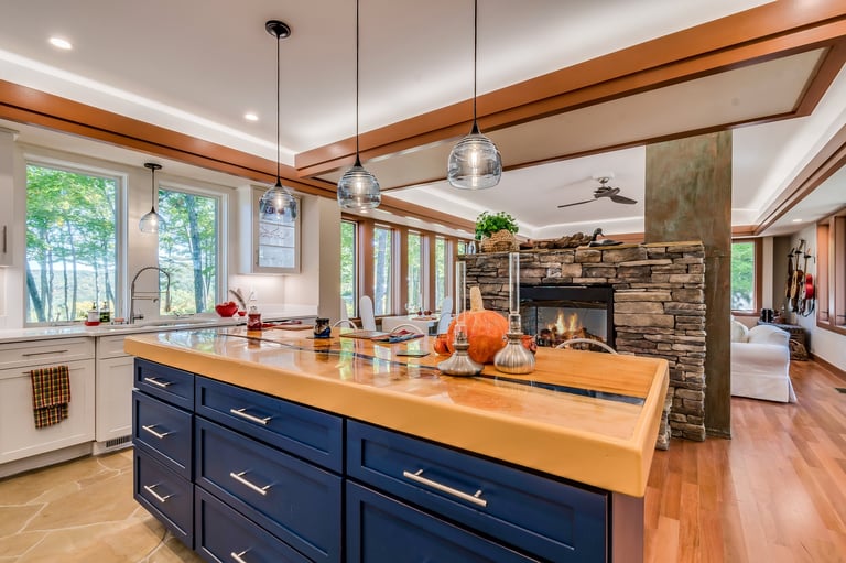 Newly remodeled kitchen with three pendant lights hanging over the island