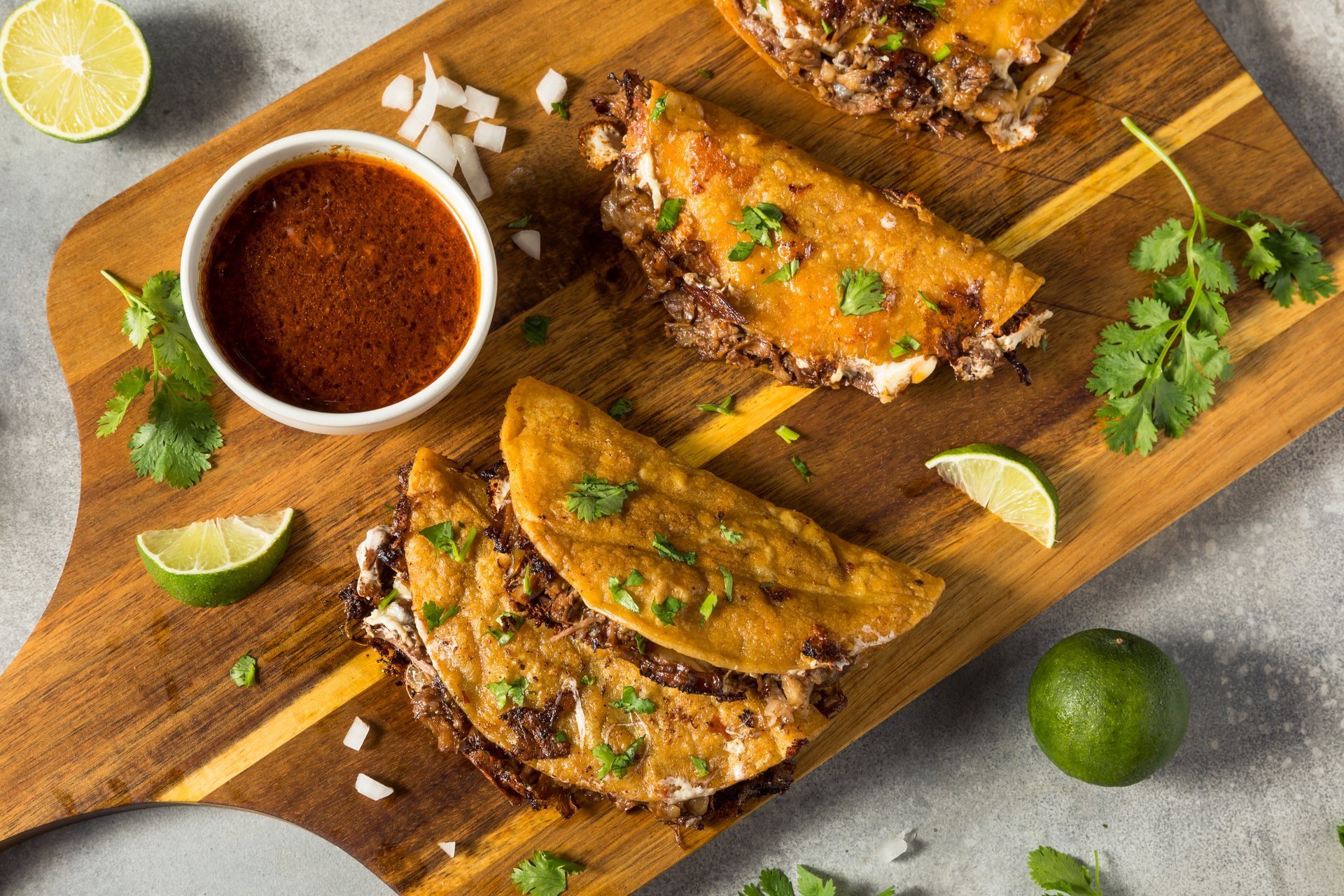 Homemade steak birria tacos with cheese and sauce