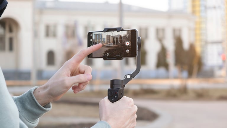 Young man filming city content with iPhone smartphone