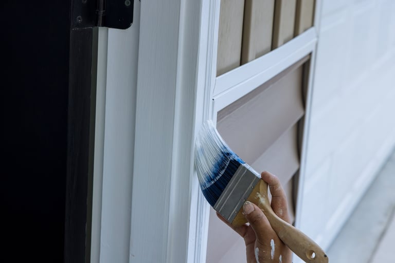 Close-up of paintbrush on door trim