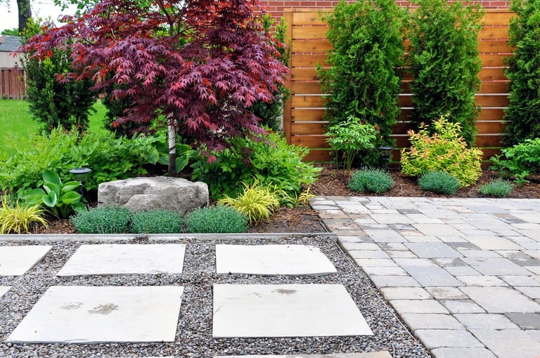 Detail of a beautiful, modern Asian-inspired patio, walkway and horizontal cedar fence in an urban backyard