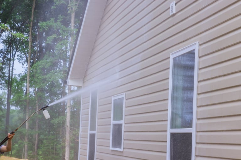 Professional pressure washing service cleaning a brick home exterior in Jamestown, Tennessee