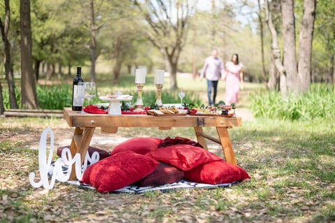 Romantic picnic with candles and florals — soft intimate outdoor setup