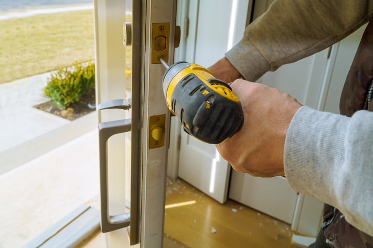 Worker installing lock with screwdriver