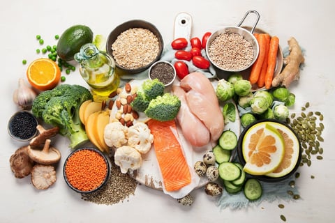 Healthy food selection including salmon, vegetables, fruits, nuts supporting hearing health