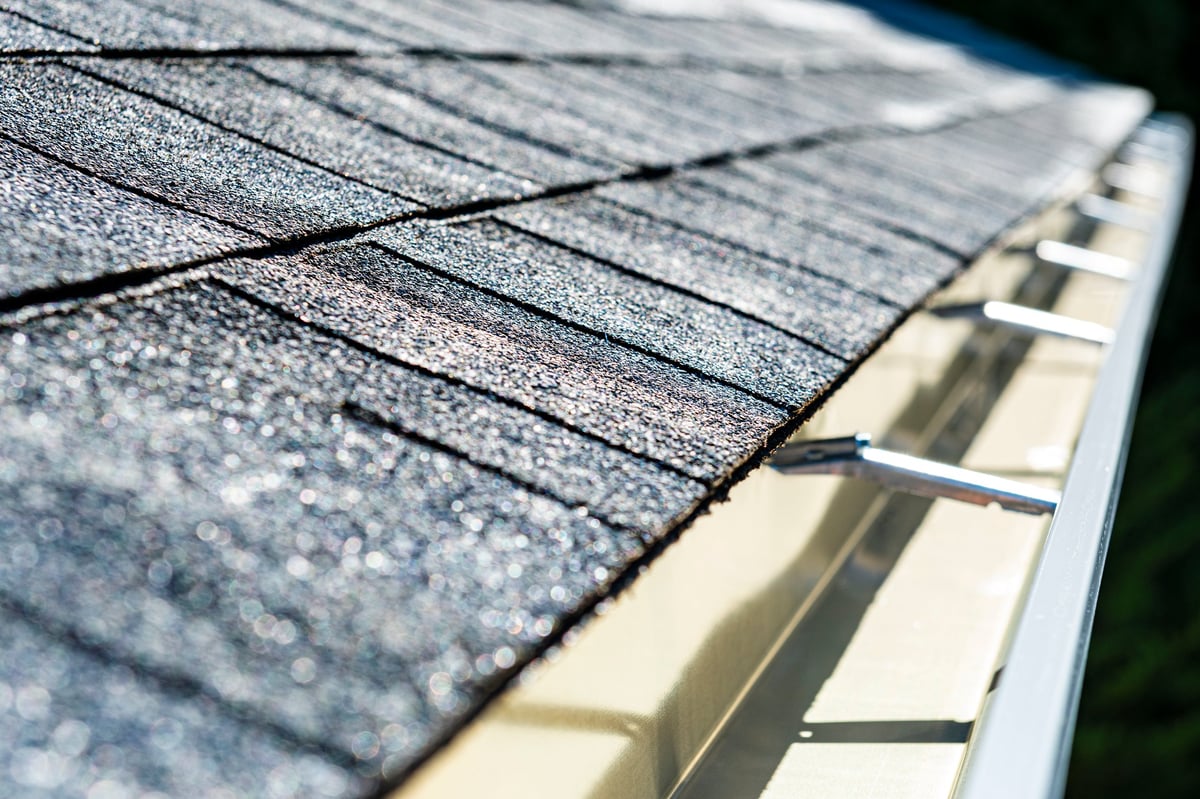 Clean aluminum rain gutters on residential home