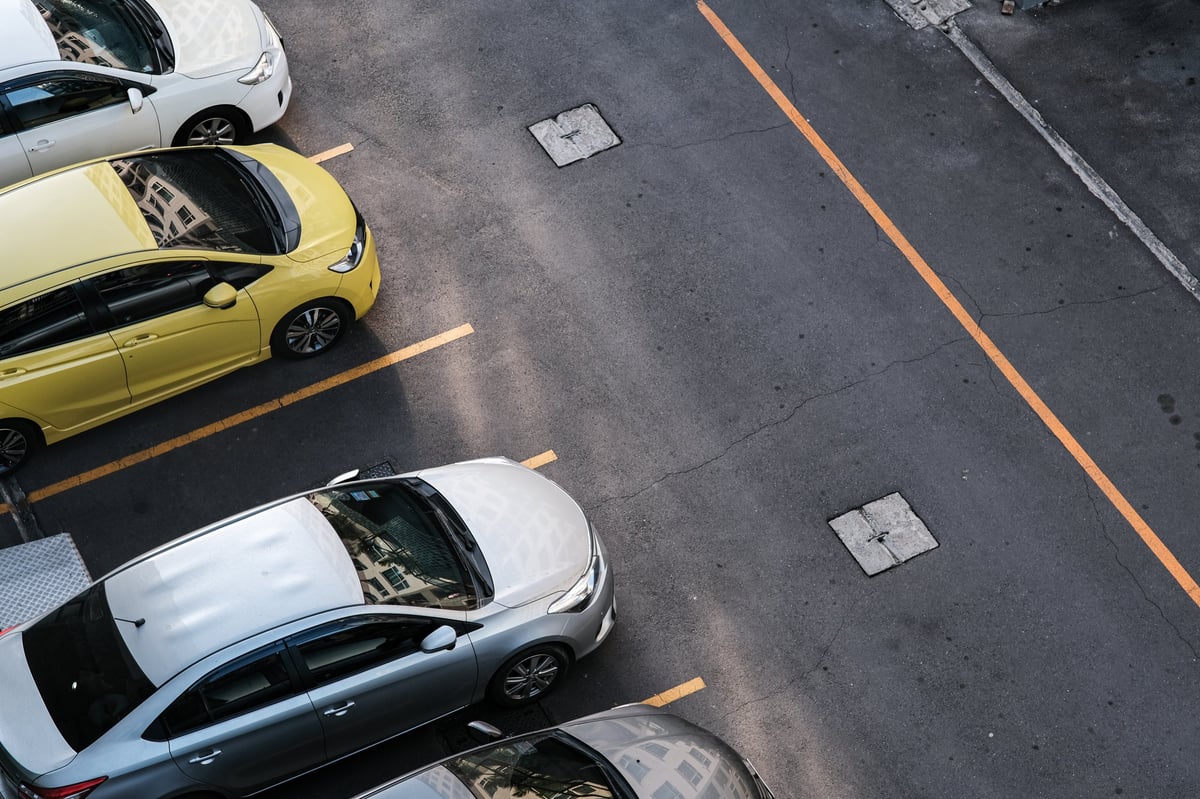 Aerial view of a colorful resident parking lot with neatly arranged vehicles