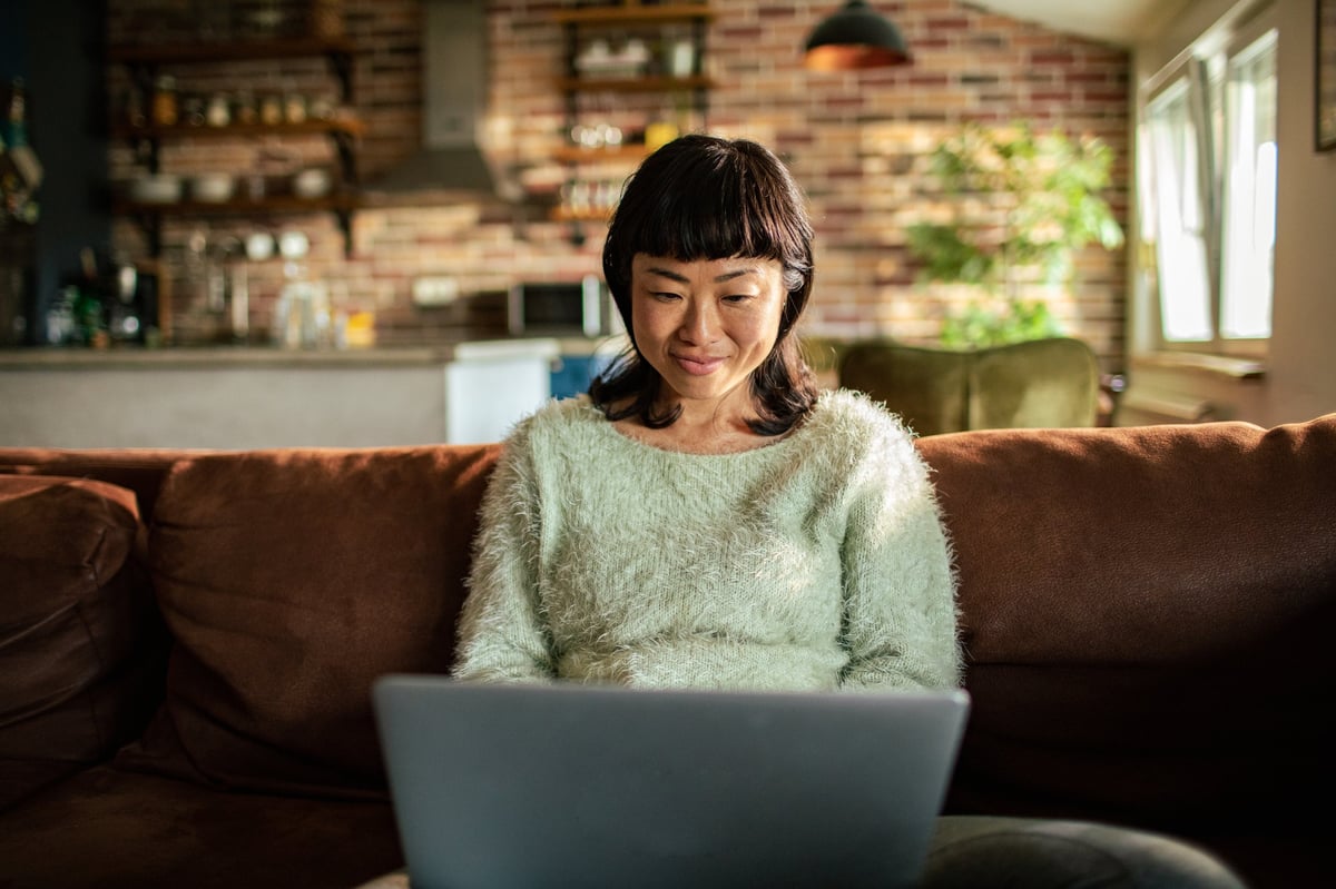 Person working from a couch with a laptop