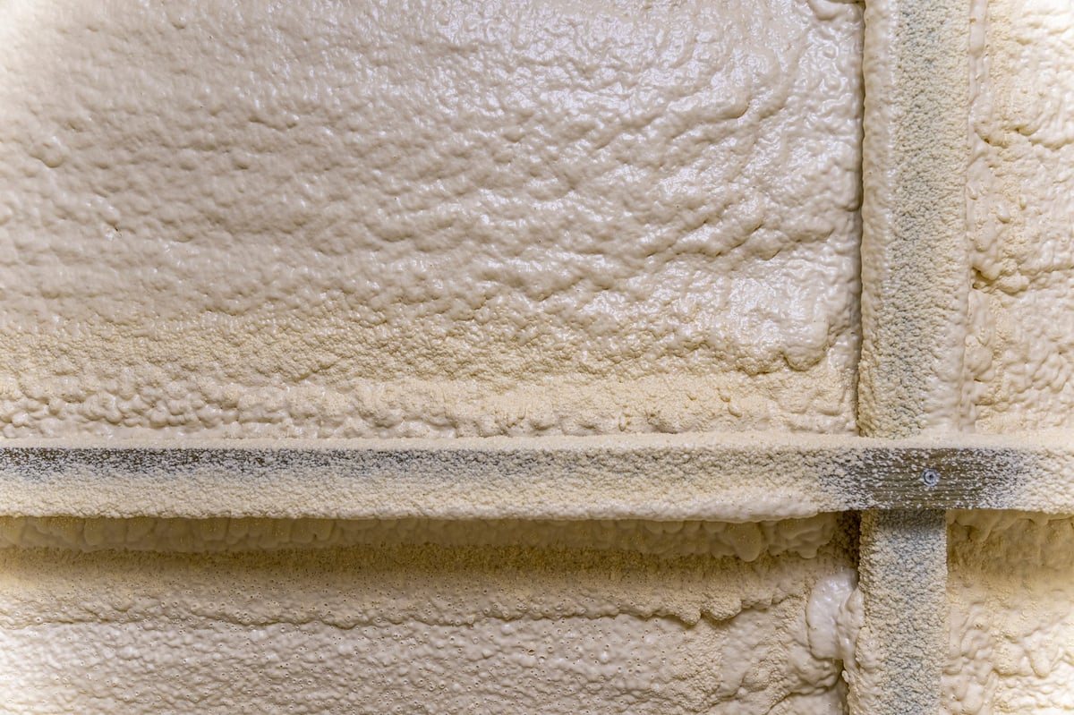Close-up of polyurethane spray foam insulation texture on walls and roof