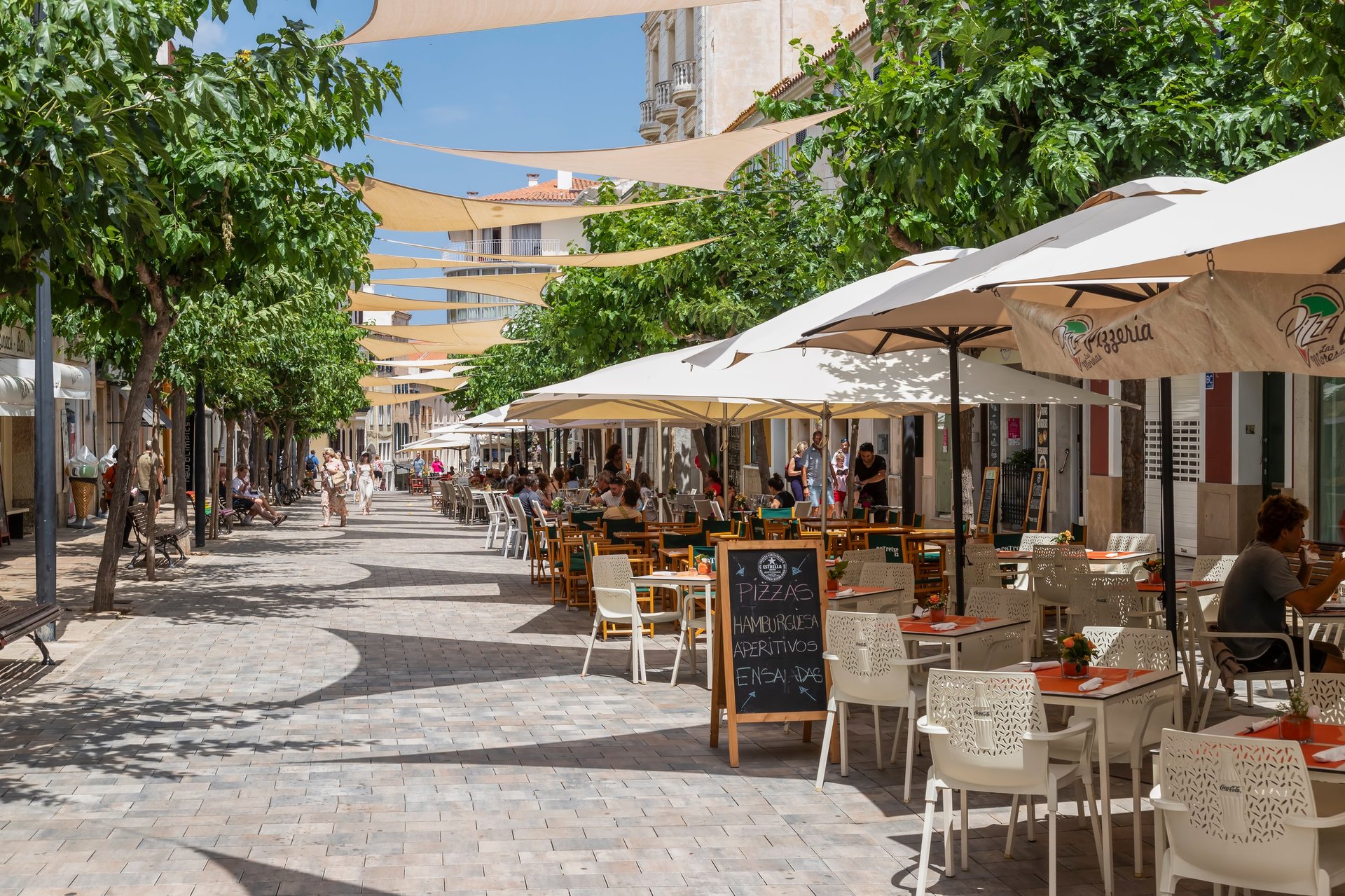 Café terraces along a city street, the kind of independent American business a CBB Group line of credit supports