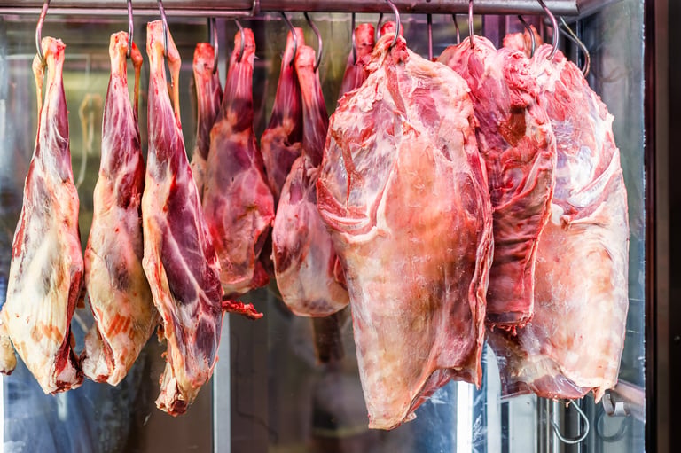 Beef hanging in refrigerated storage