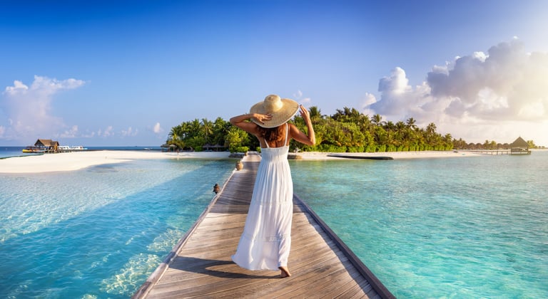 Woman walking towards tropical island in Maldives