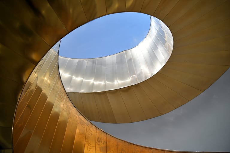 Spiral staircase in grey and gold materials