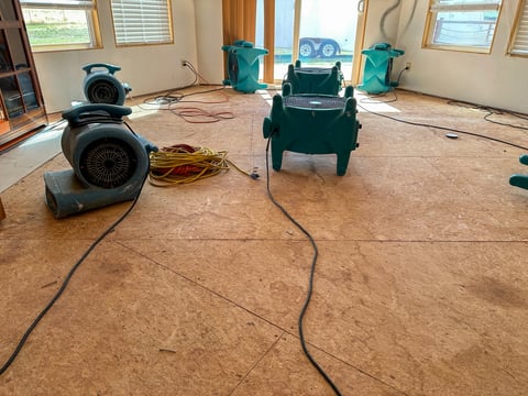 Air movers drying a home after water loss
