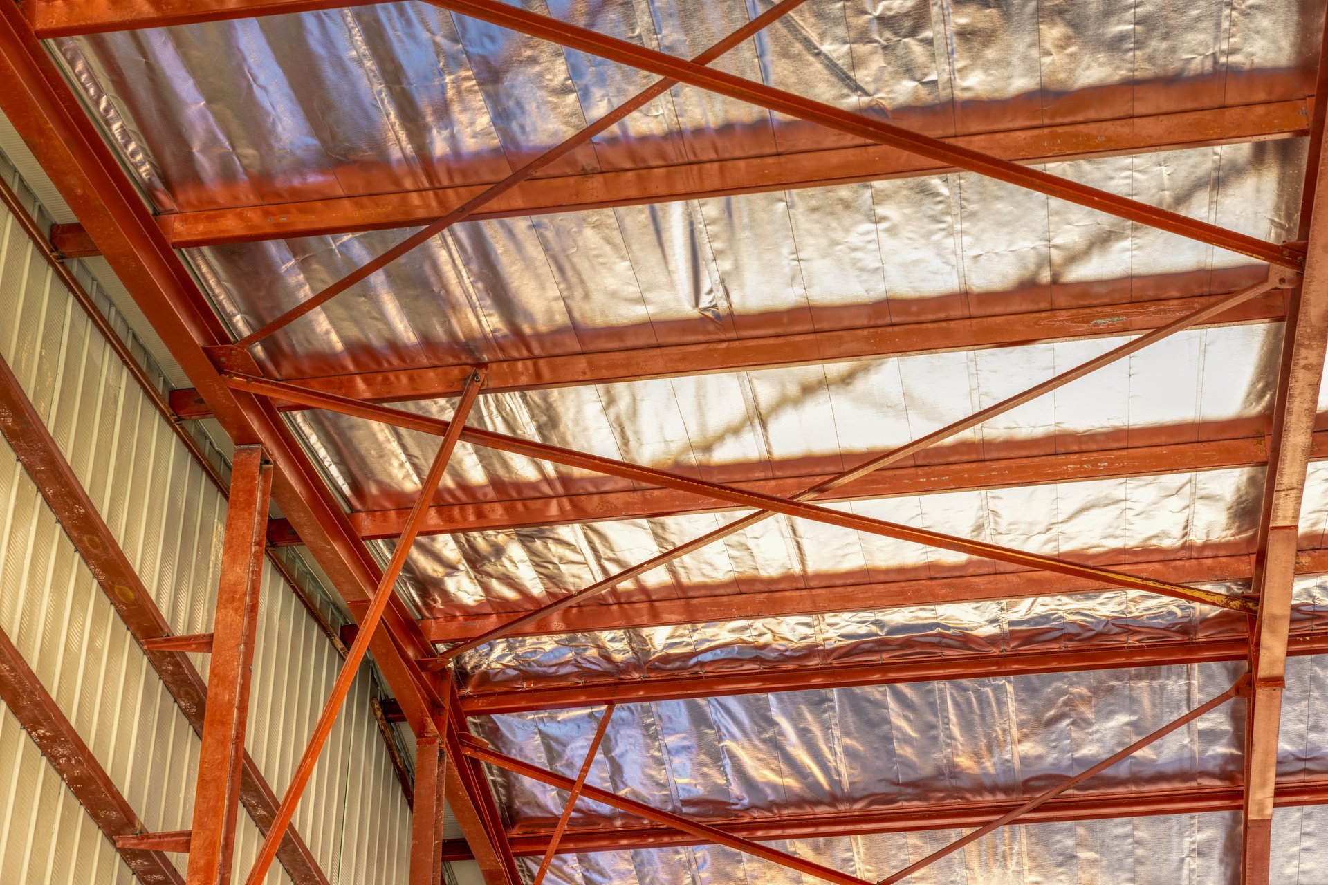 Roof insulation indoors industrial warehouse with corrugated metal sheet and aluminum foil