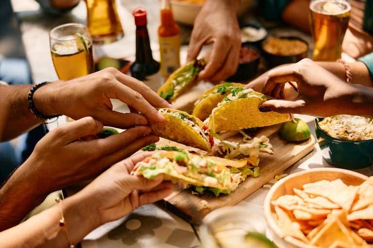 Happy customers enjoying Mexican food together at Chelita's Tacos