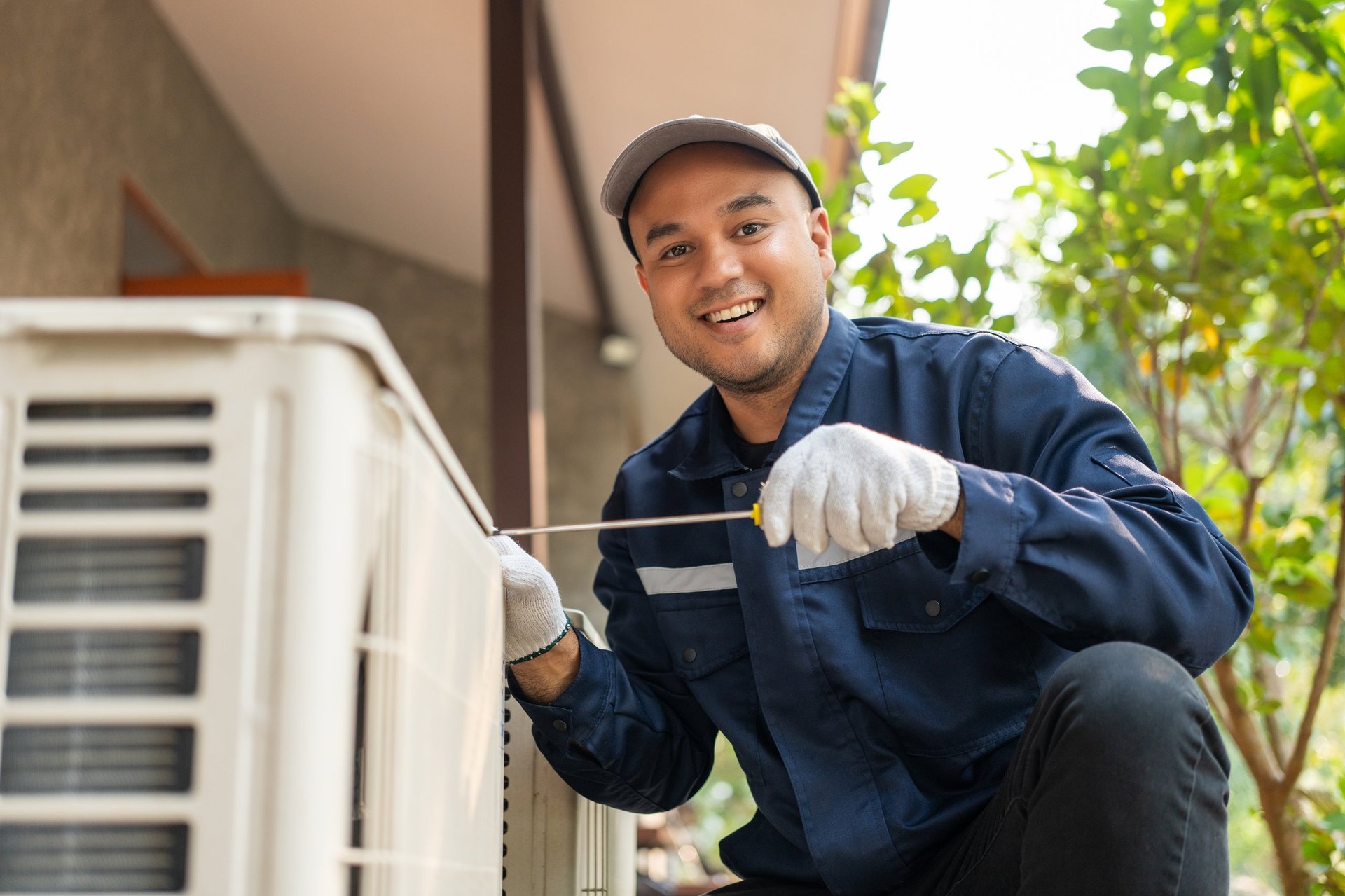 HVAC technician performing AC maintenance and cleaning filters