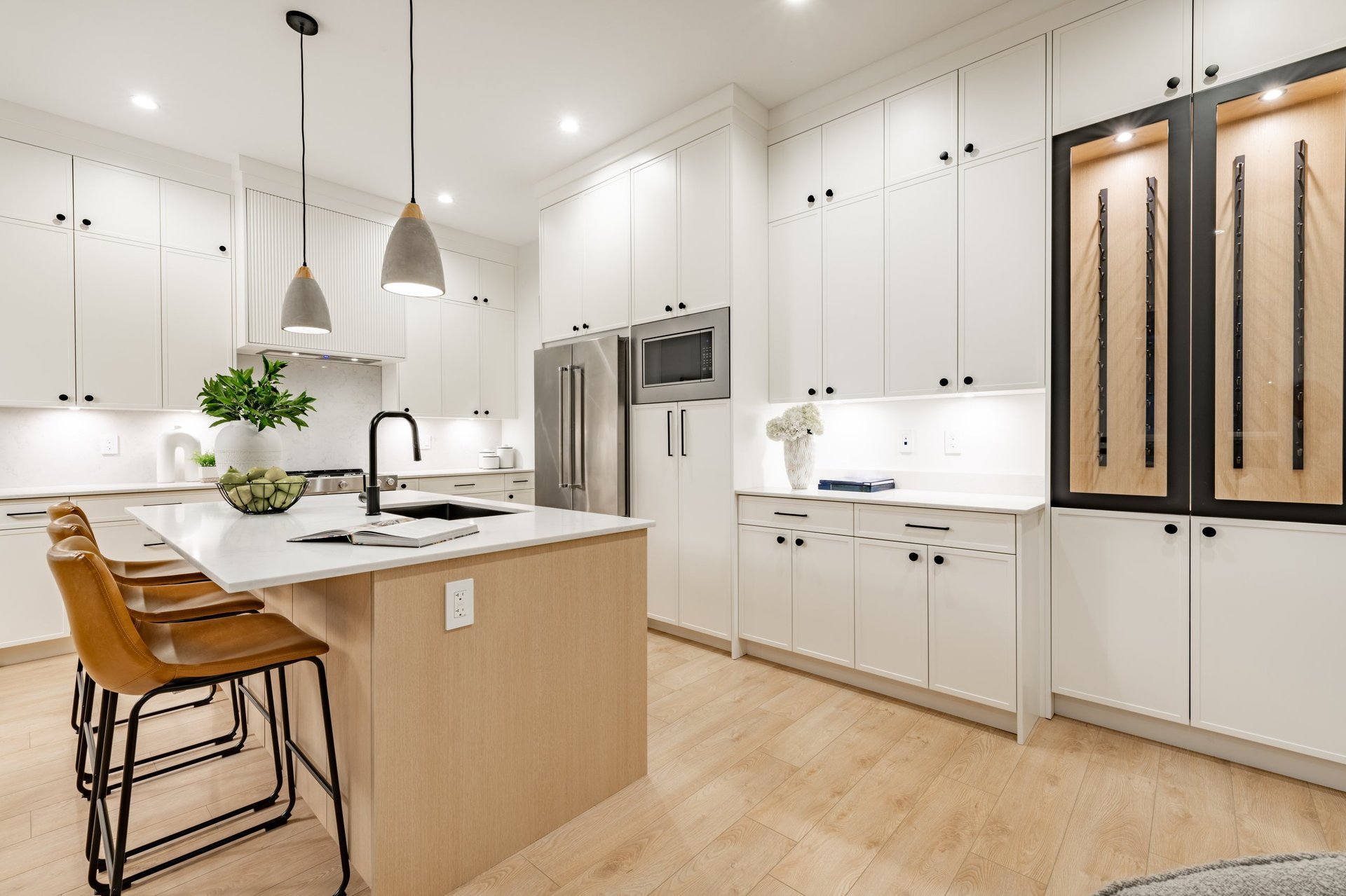 Luxury kitchen and dining room with island and coastal twilight views