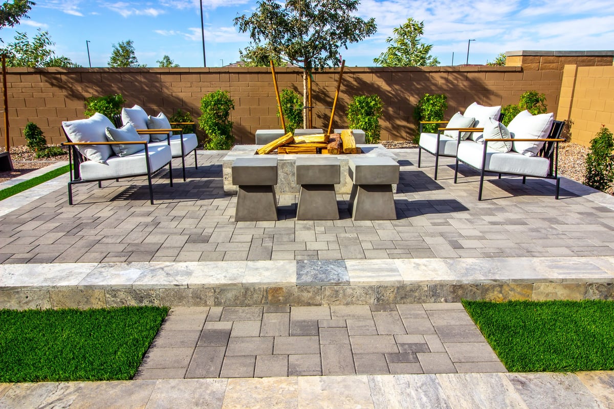 Multi-level interlock patio with fire pit area and seating wall — Ottawa backyard hardscaping design