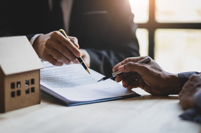 Parents reviewing campus-area housing documents with a real estate advisor