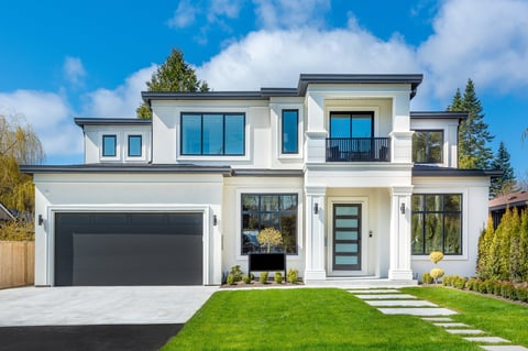 Exterior views of a large contemporary modern home with pillars and lush landscaping