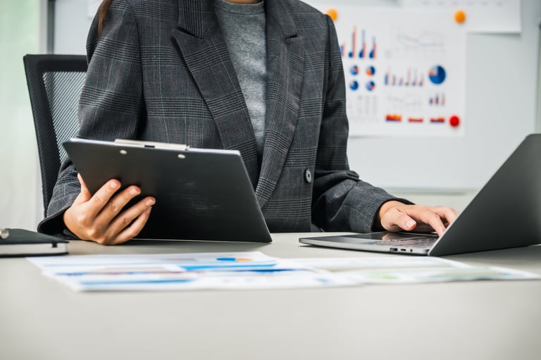 Senior financial professional reviewing documents at an executive desk