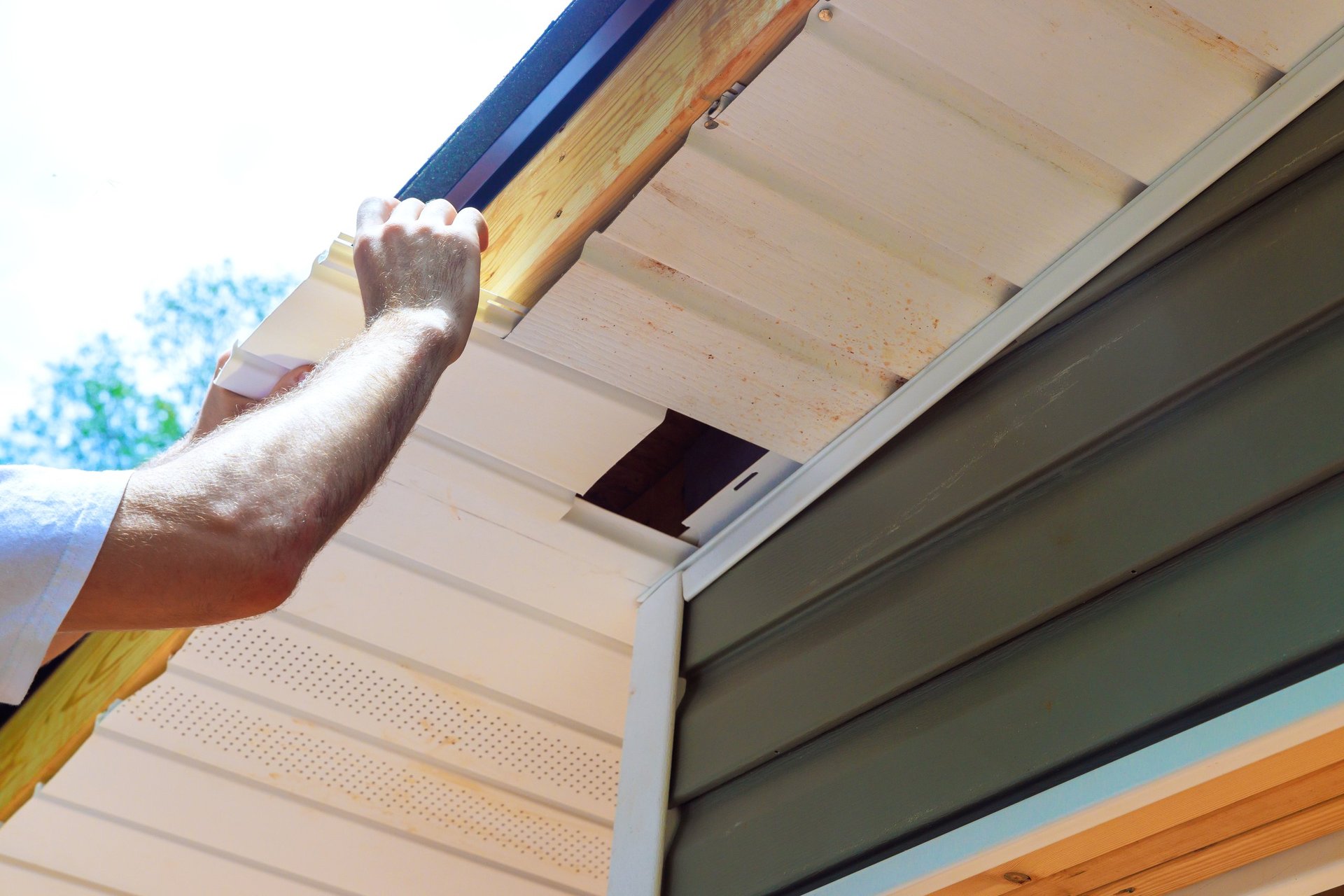 Roofer installing white uPVC fascia board on a residential property in Doncaster