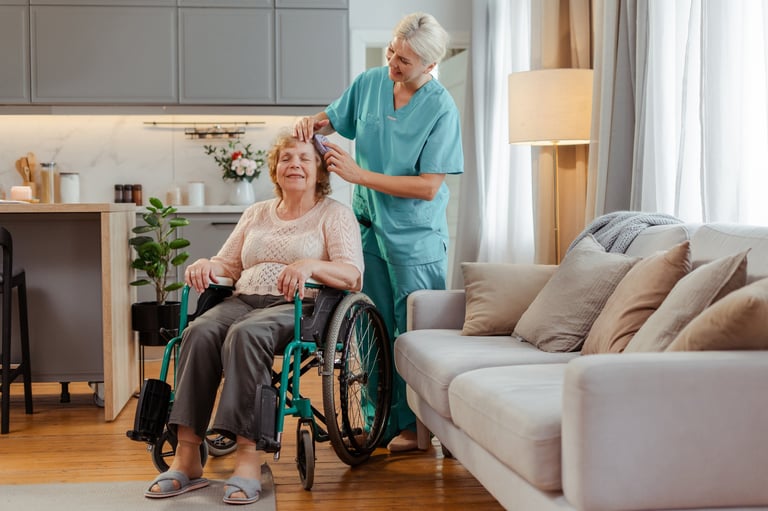 Nurse caring for happy senior woman in wheelchair at home