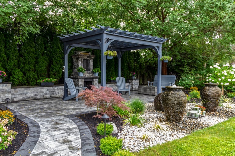 Large pergola on pavers with stone fireplace