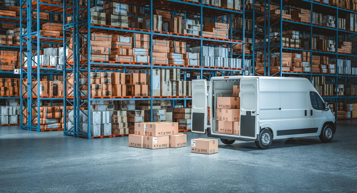 Camioneta de reparto frente a almacén de distribución con cajas