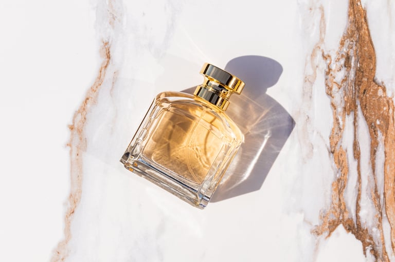 Perfume bottle with gold cap on marble