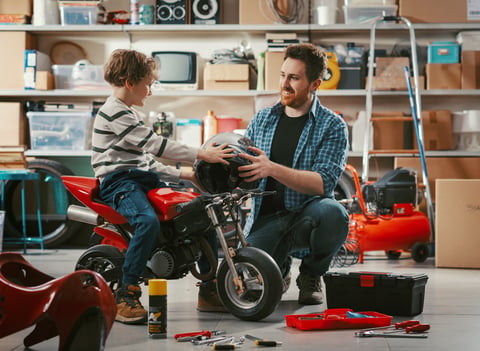 Customer with dirt bike at the shop