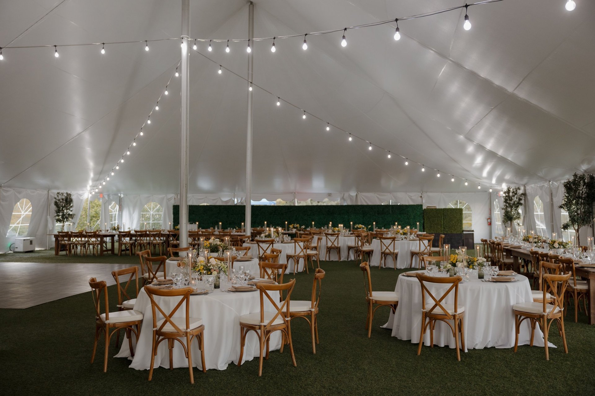 Beautifully decorated wedding tent interior with string lights