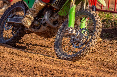 Muddy off-road motorcycle — we service these