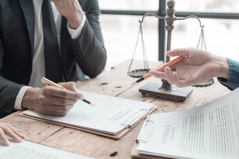 Male lawyer working with contract documents and wooden hammer